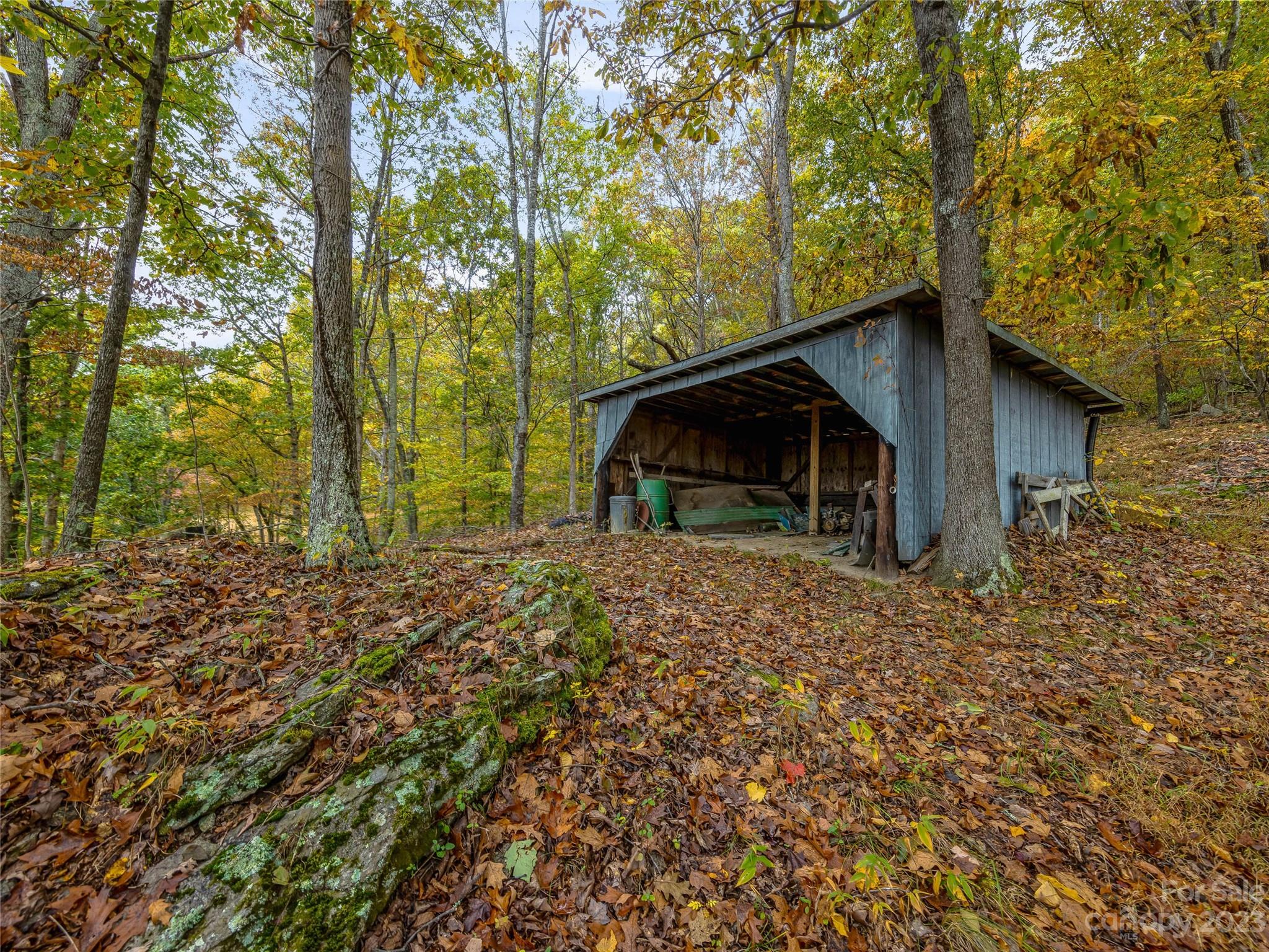 1200 Redmon Road Marshall, NC 28753 - Photo 37 of 37 a backyard of a house with wooden fence and trees