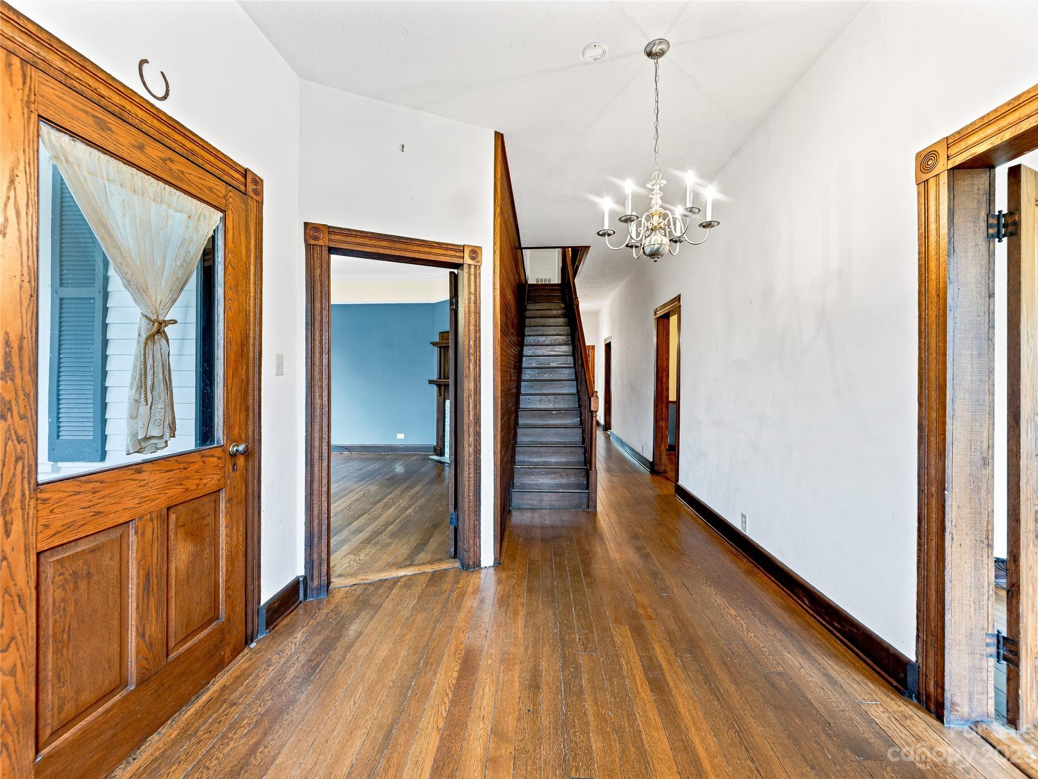 1200 Redmon Road Marshall, NC 28753 - Photo 7 of 37 a view of a hallway with wooden floor and a chandelier