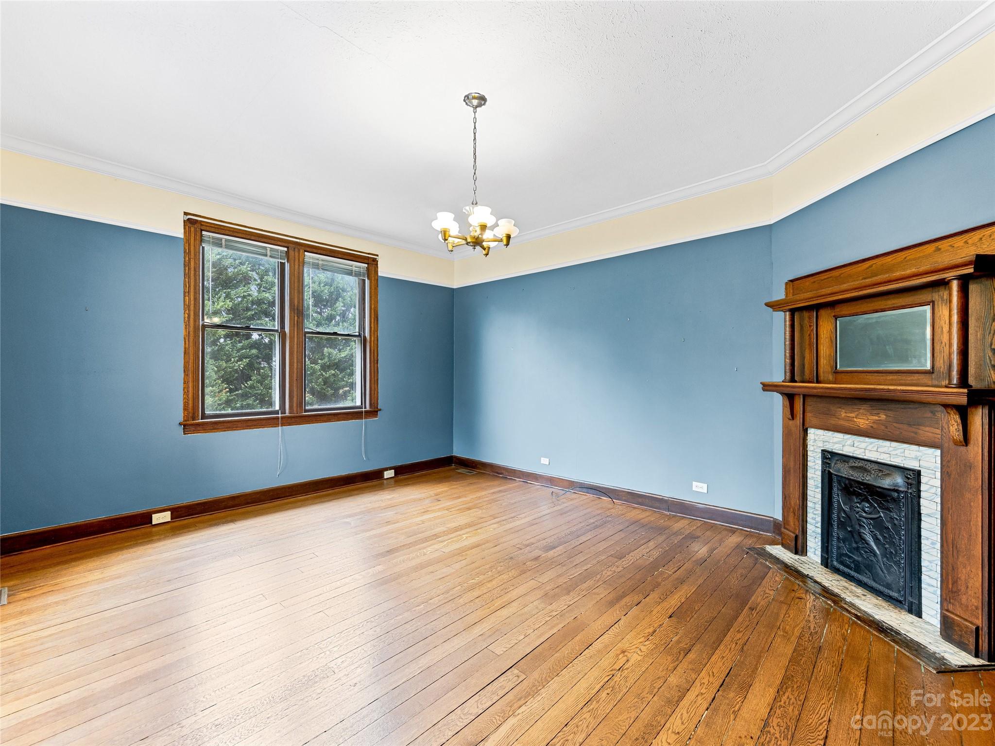 1200 Redmon Road Marshall, NC 28753 - Photo 8 of 37 an empty room with windows and fireplace