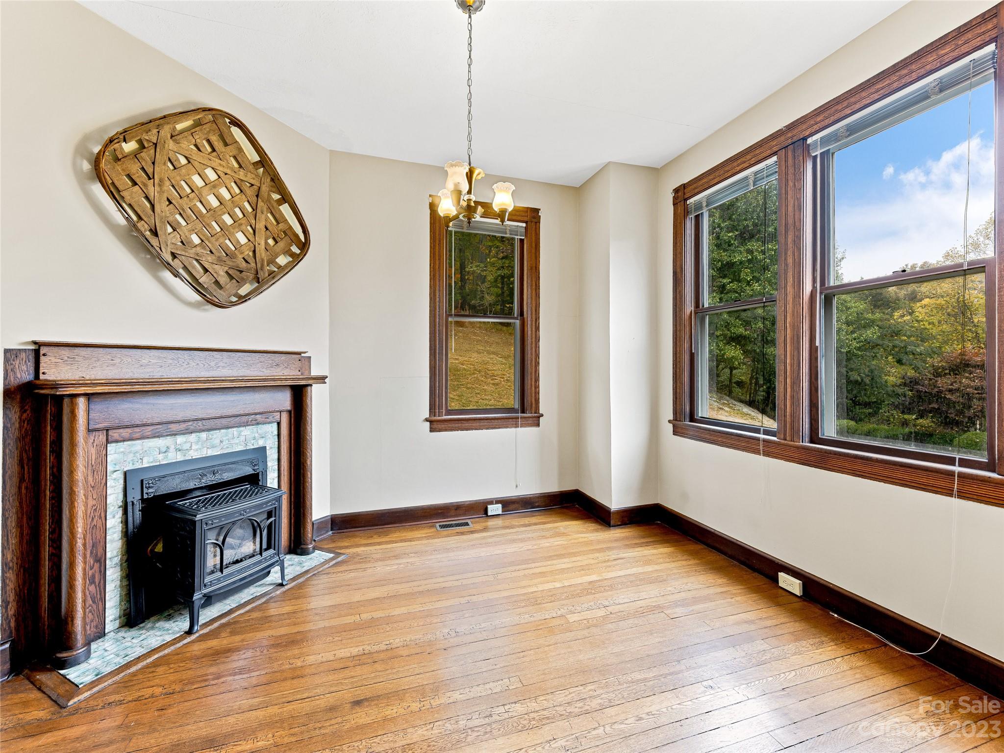 1200 Redmon Road Marshall, NC 28753 - Photo 10 of 37 a view of an empty room with wooden floor fireplace and a window