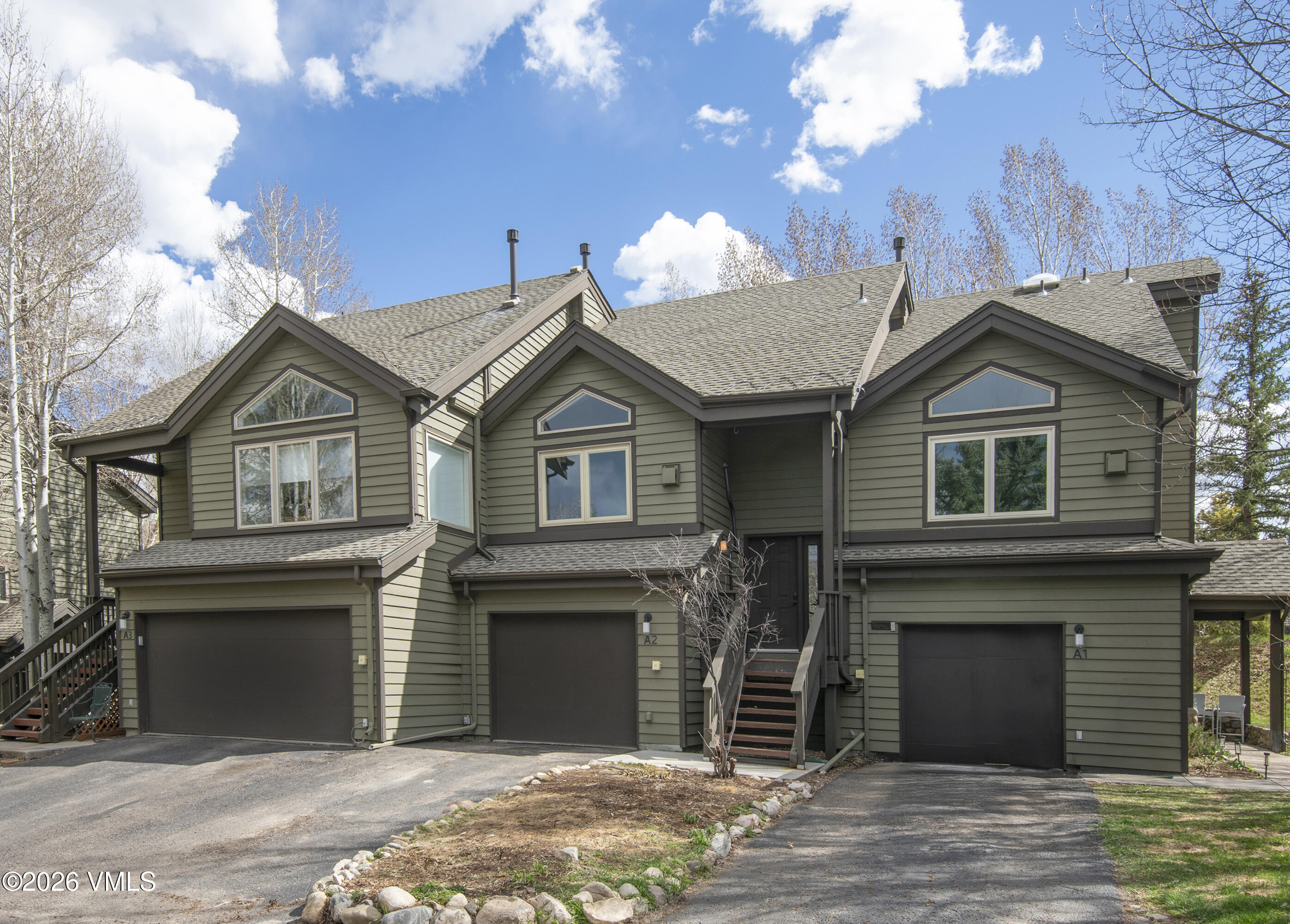 83 Arlington Place, Unit A2 Edwards, CO 81632 - Photo 1 of 19 a front view of a house with a yard and garage