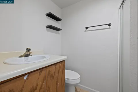 a bathroom with a sink toilet and a mirror