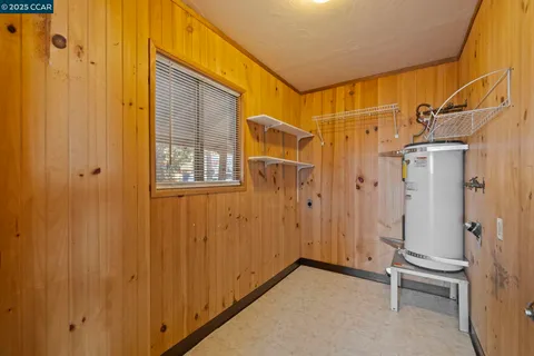 a view of a bathroom with a shower and wooden door