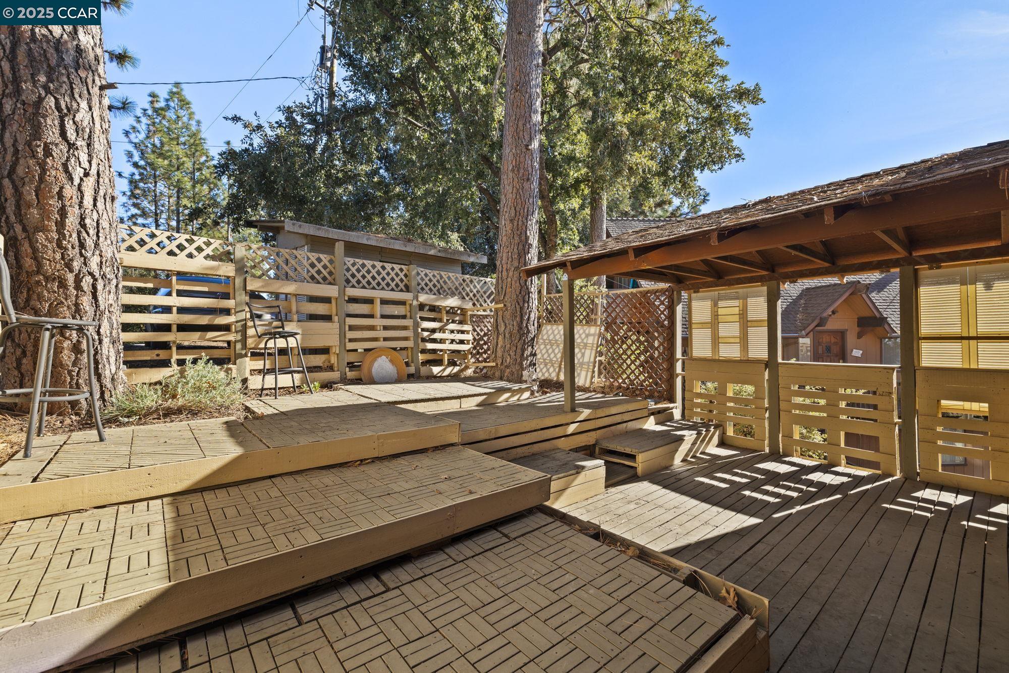 18957 Stag Circle Tuolumne, CA 95379 - Photo 13 of 22 a view of a balcony with wooden floor and outdoor seating