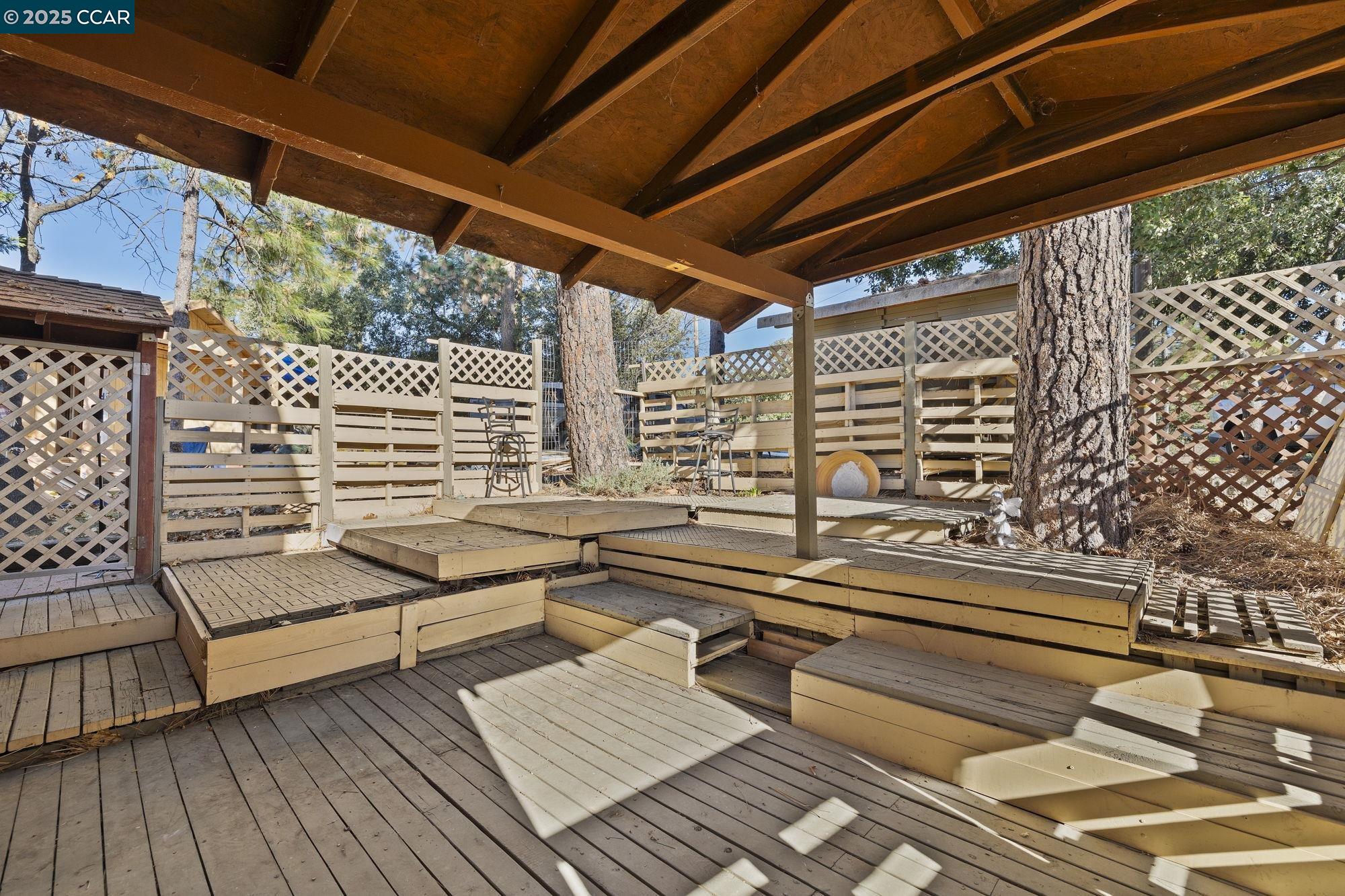 18957 Stag Circle Tuolumne, CA 95379 - Photo 14 of 22 a roof deck with wooden floor and outdoor seating