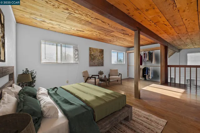 a bed sitting in a bedroom next to a window