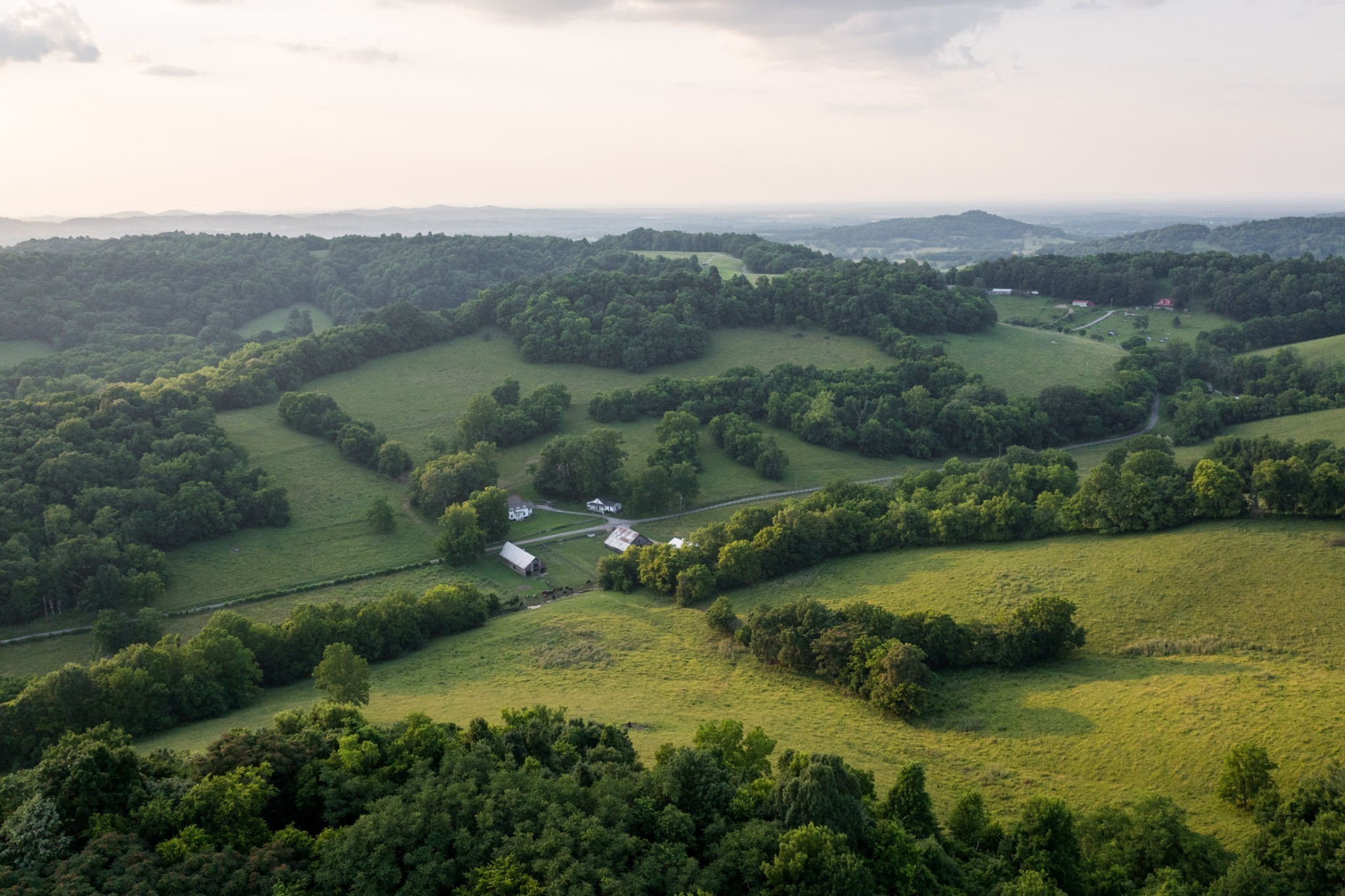 2405 Thompson Road Lewisburg, TN 37091 - Photo 65 of 71 an aerial view of green landscape with trees houses and mountain view