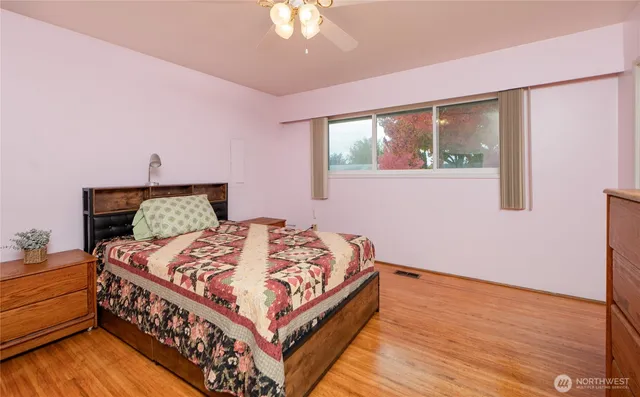 a bed sitting in a bedroom next to a window
