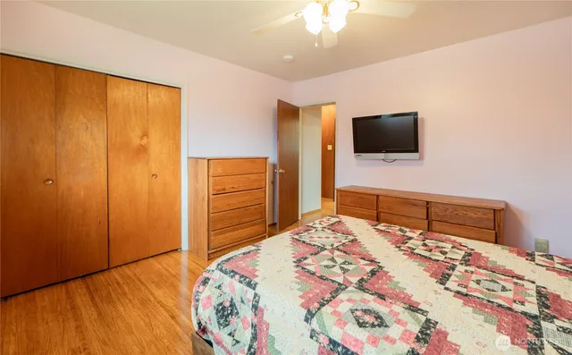 a bedroom with a bed and a flat screen tv