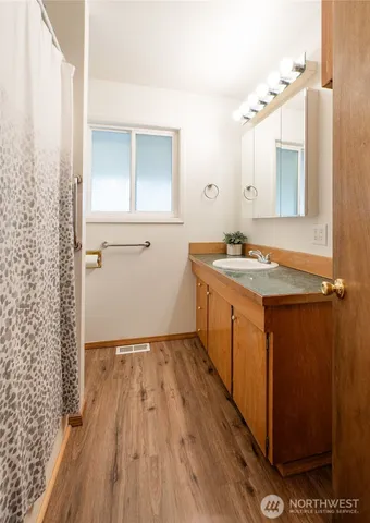 a bathroom with a sink and mirror