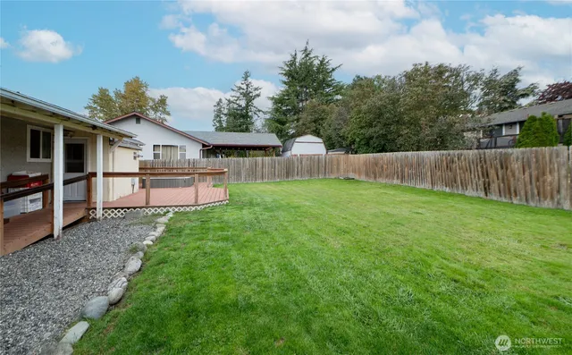 a front view of a house with a garden and deck