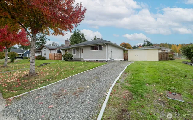 a view of a house with a yard and potted plants