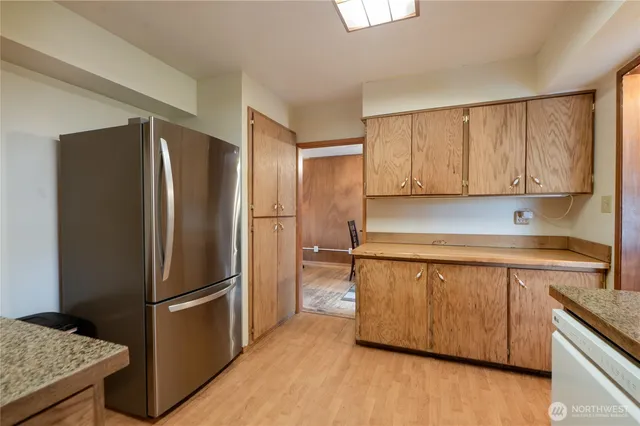 a kitchen with stainless steel appliances granite countertop a refrigerator and a stove