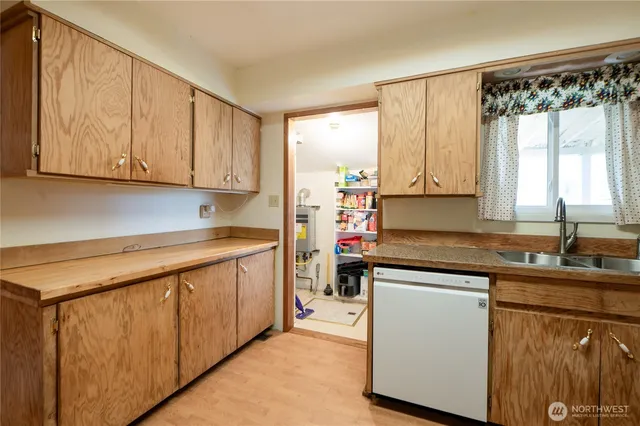 a kitchen with a sink window and cabinets
