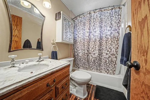 a bedroom with bed and wooden floor