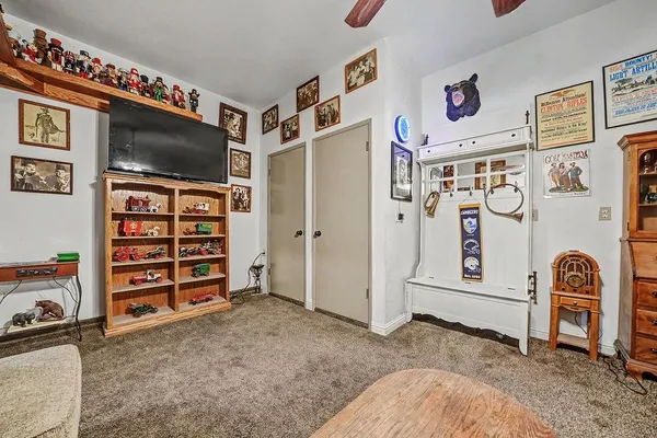 a view of a bedroom with wooden floor and door