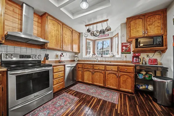 a open kitchen with stainless steel appliances granite countertop a stove and cabinets