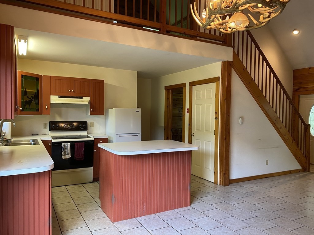 72 North Hillside Road Deerfield, MA 01373 - Photo 8 of 29 a kitchen with stainless steel appliances granite countertop a stove a sink dishwasher and a refrigerator