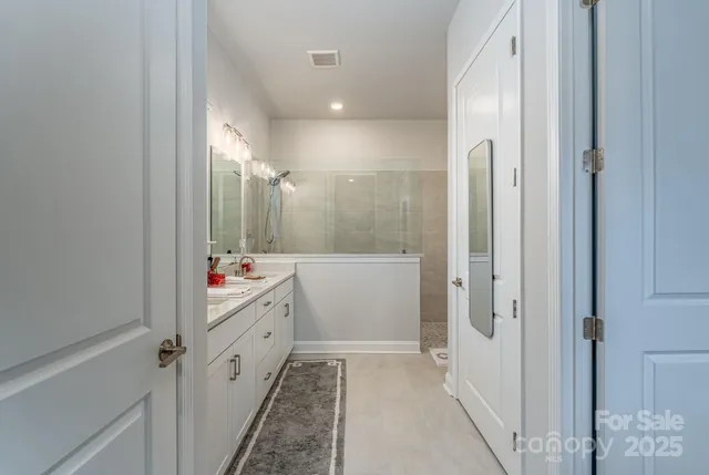 a bathroom with a mirror and a shower