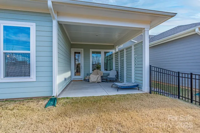a view of an house with backyard and balcony