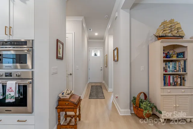 a hallway with fireplace and cabinets