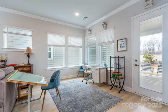 a living room with furniture a rug and a window