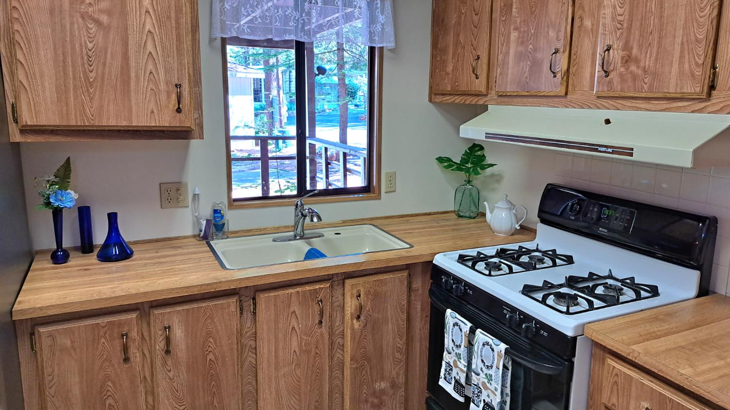 5766 Pony Express Trail, Unit 4 Pollock Pines, CA 95726 - Photo 10 of 17 a kitchen with granite countertop a sink stove and cabinets