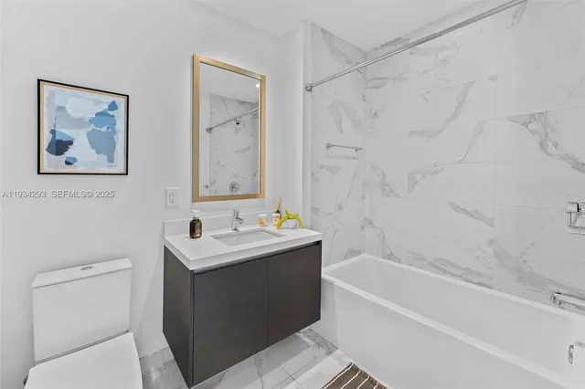 a bathroom with a sink a toilet and a bathtub