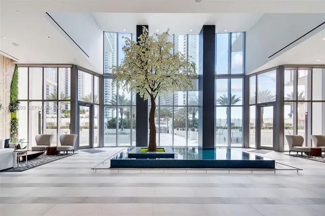 a living room filled with furniture and a large window