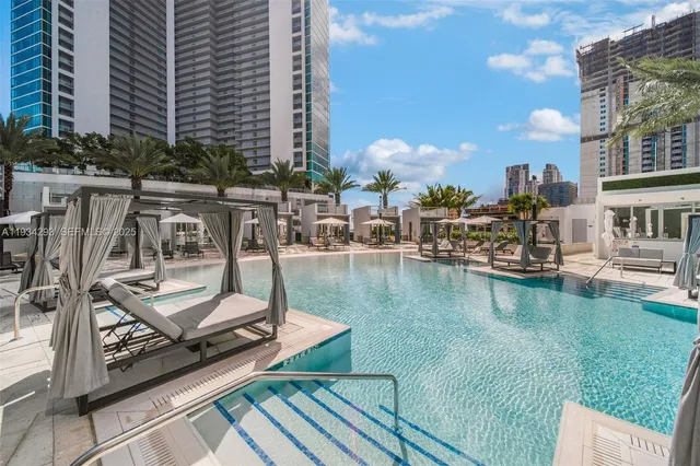 a view of a swimming pool with chairs