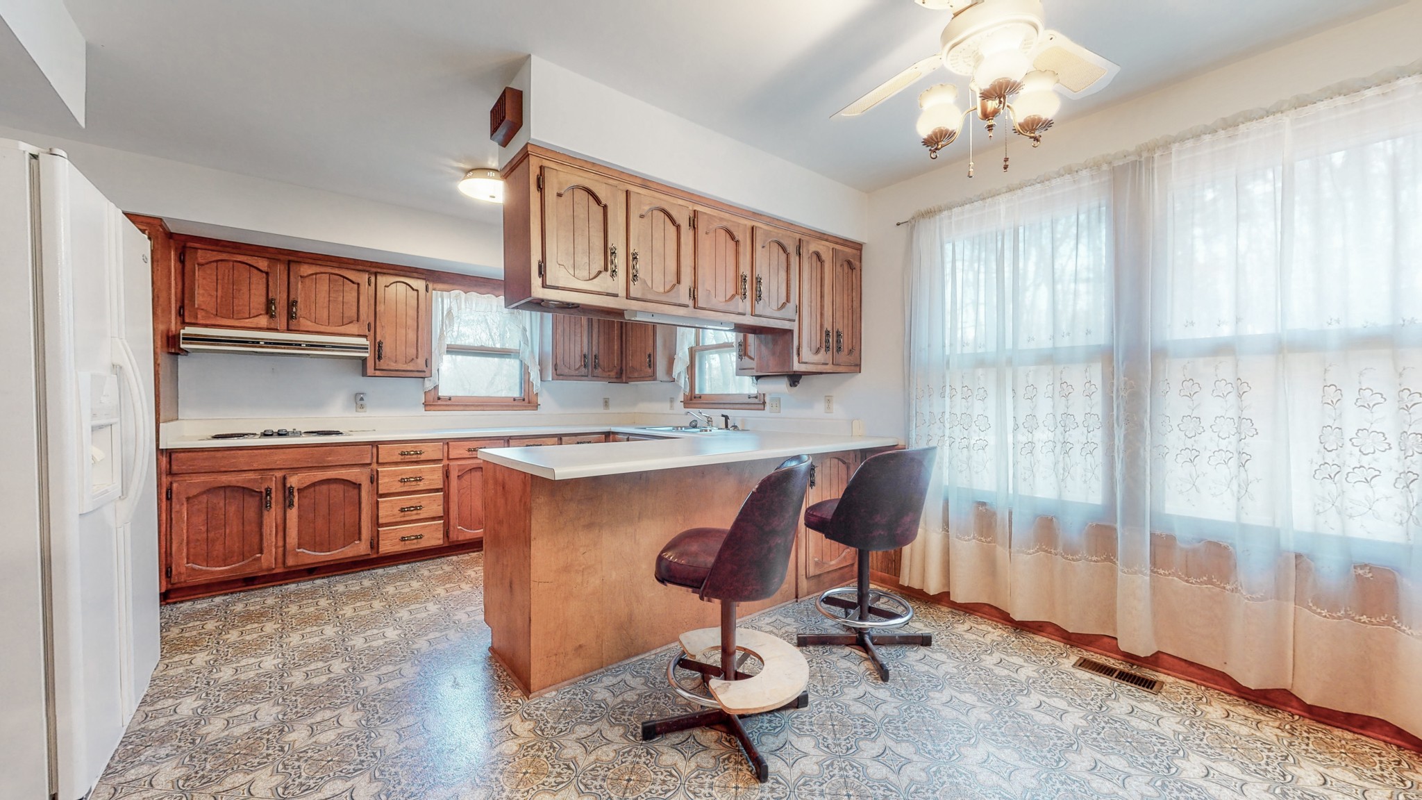 2124 Hillsboro Road Franklin, TN 37069 - Photo 12 of 44 a view of kitchen with granite countertop a sink dishwasher a dining table and chair with wooden floor