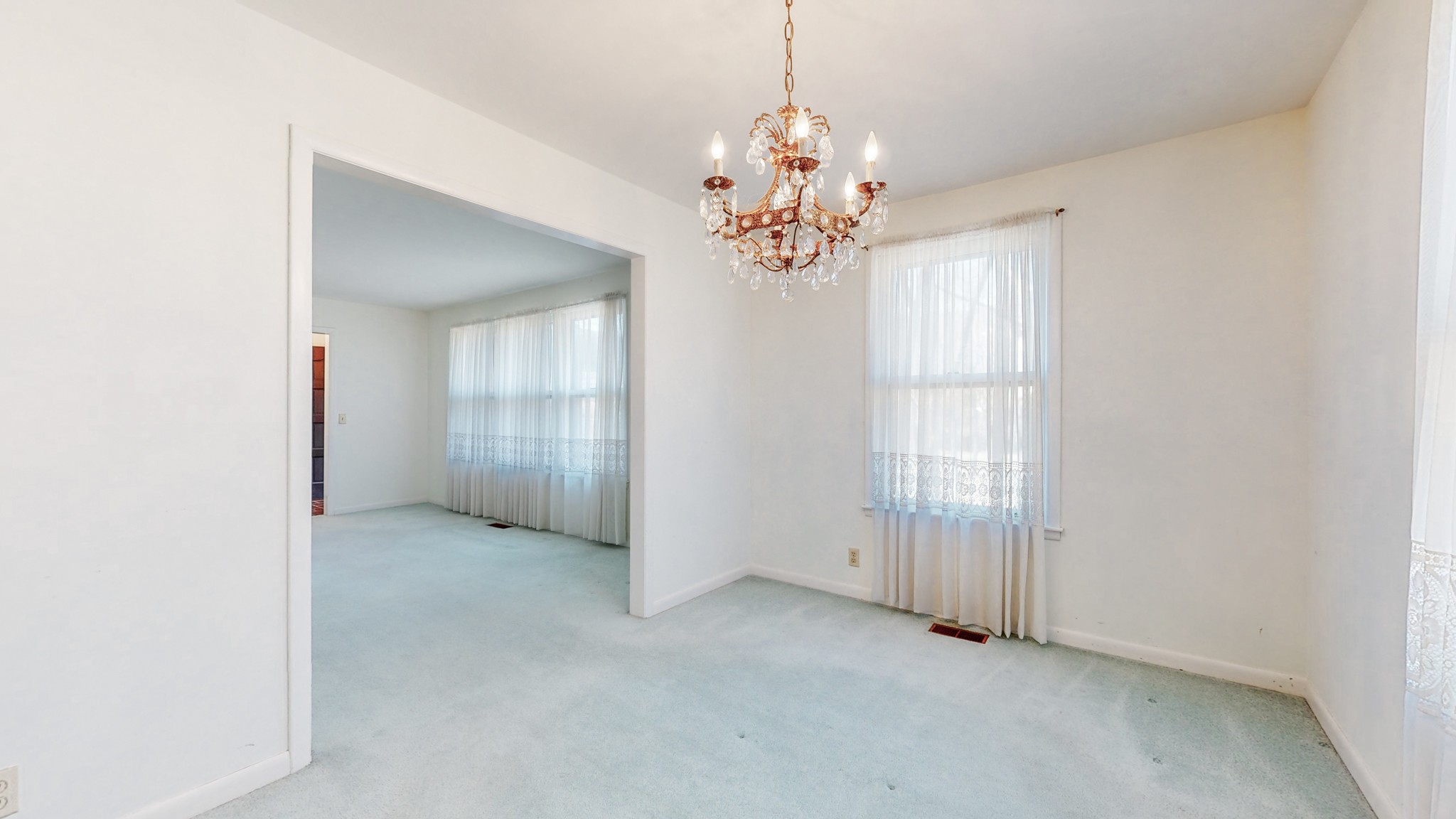 2124 Hillsboro Road Franklin, TN 37069 - Photo 10 of 44 an empty room with chandelier and windows
