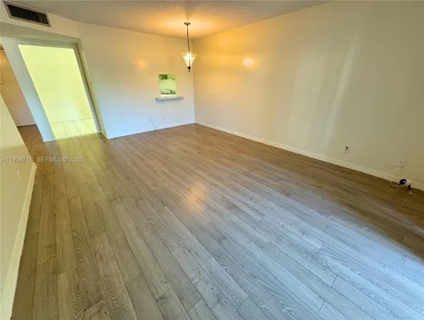 a view of a big room with wooden floor