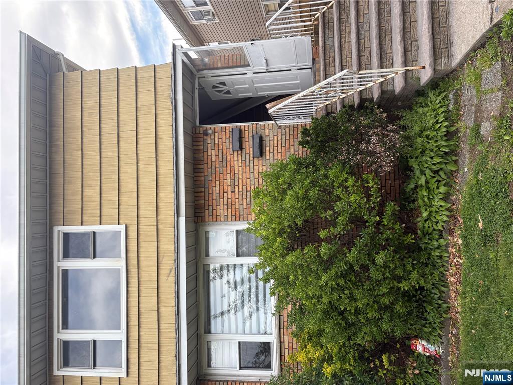 10 Strong Street, Unit 2 Wallington, NJ 07057 - Photo 1 of 12 a front view of a house with plants