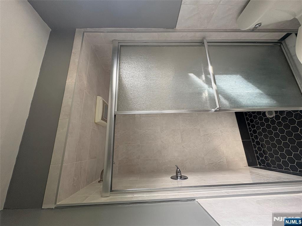 10 Strong Street, Unit 2 Wallington, NJ 07057 - Photo 12 of 12 a bathroom with a glass shower door