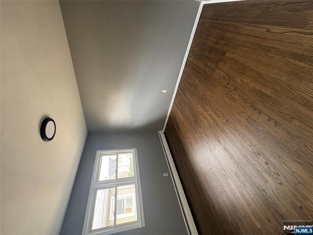 10 Strong Street, Unit 2 Wallington, NJ 07057 - Photo 3 of 12 an empty room with wooden floor and windows