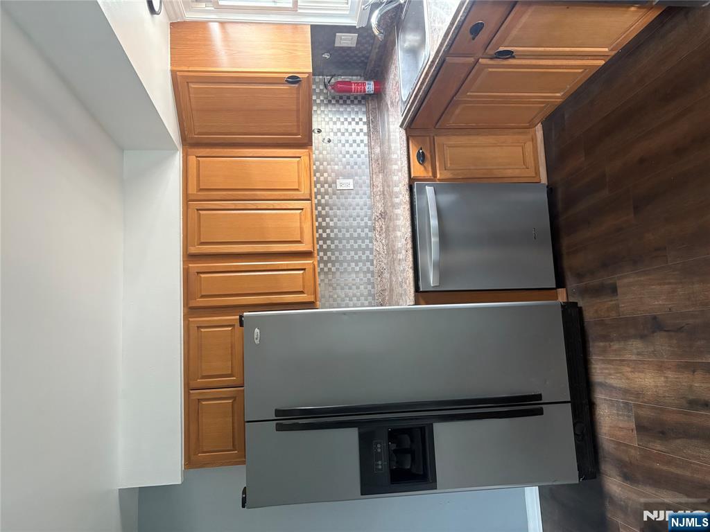 10 Strong Street, Unit 2 Wallington, NJ 07057 - Photo 4 of 12 a kitchen with granite countertop a refrigerator sink and cabinets
