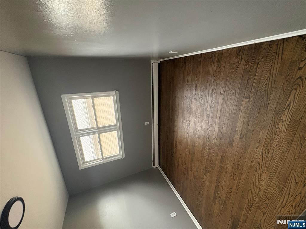 10 Strong Street, Unit 2 Wallington, NJ 07057 - Photo 7 of 12 wooden floor in an empty room with a window