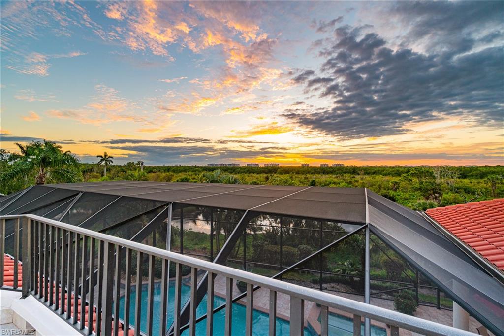 208 Audubon Boulevard Naples, FL 34110 - Photo 12 of 45 a view of a balcony with wooden floor and fence