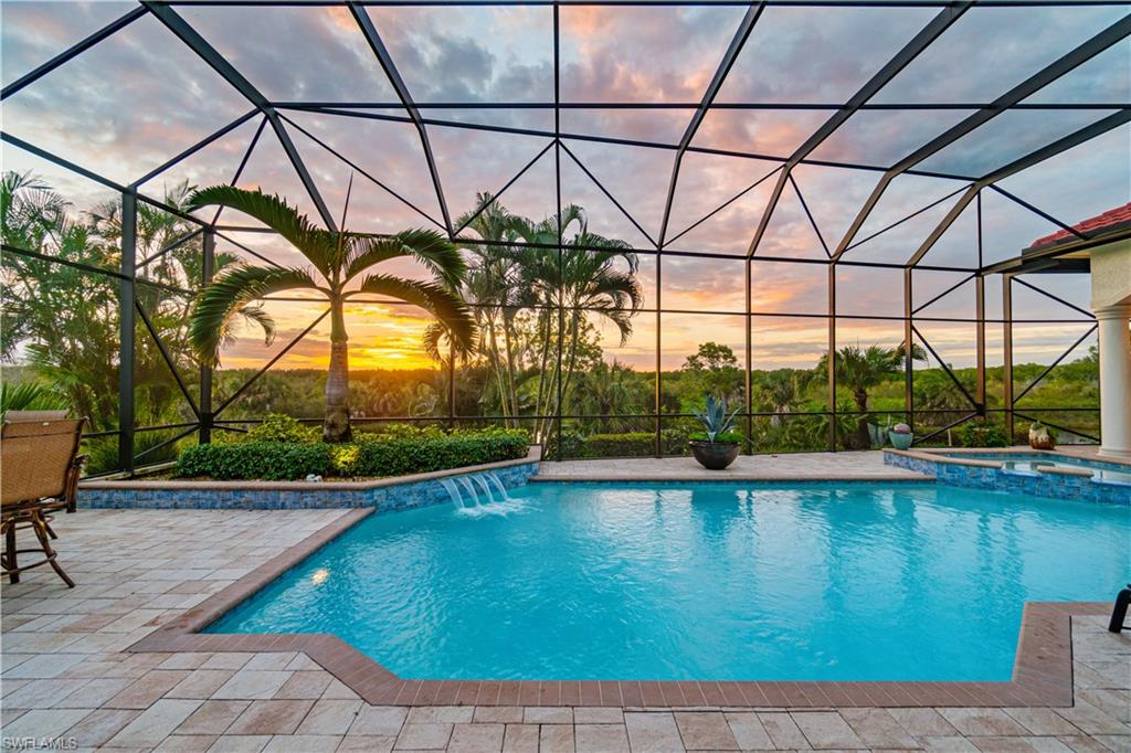 208 Audubon Boulevard Naples, FL 34110 - Photo 13 of 45 a view of a swimming pool and a chair