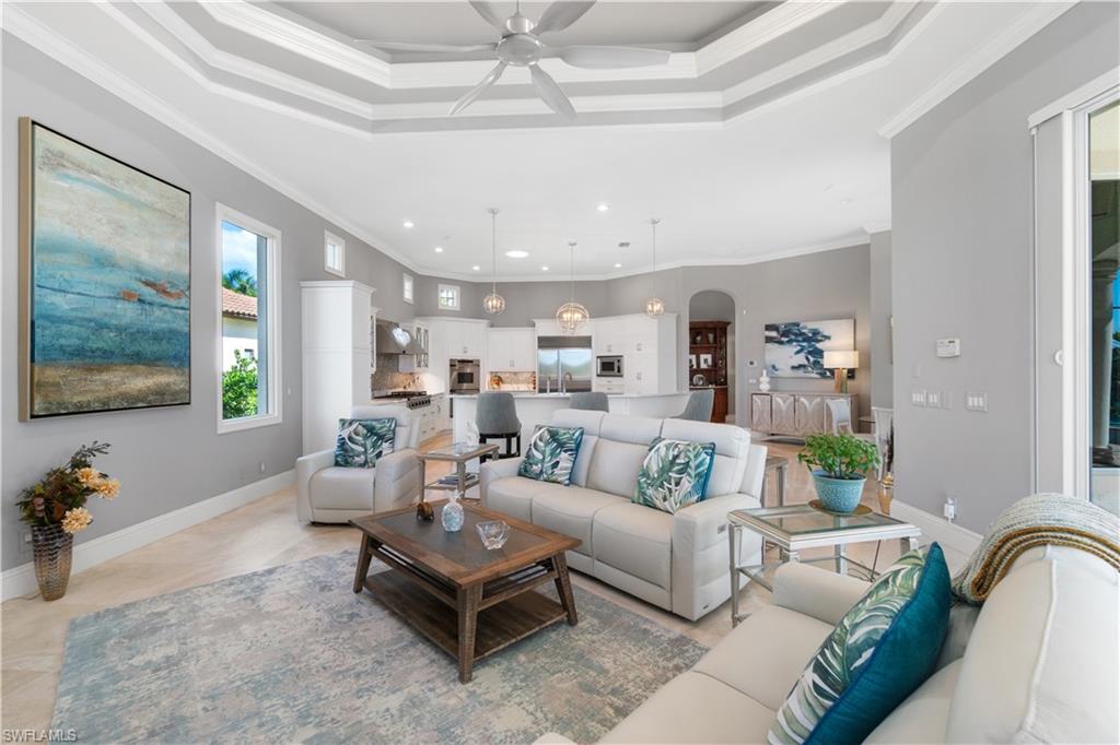 208 Audubon Boulevard Naples, FL 34110 - Photo 25 of 45 a living room with furniture and a flat screen tv