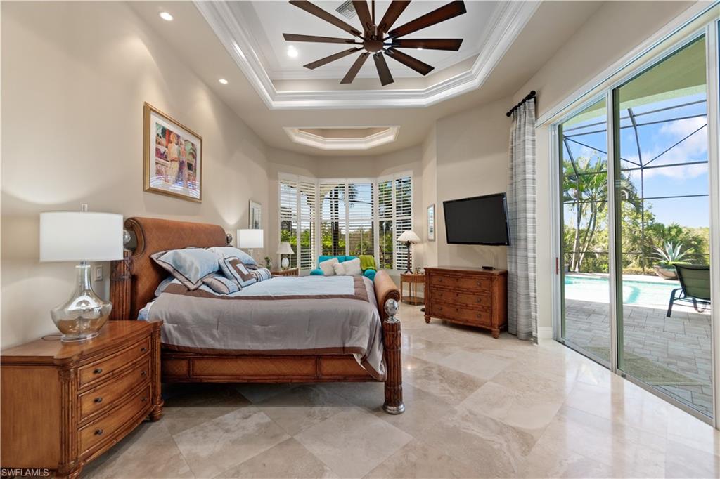 208 Audubon Boulevard Naples, FL 34110 - Photo 28 of 45 a bedroom with a bed and glass walk in closet