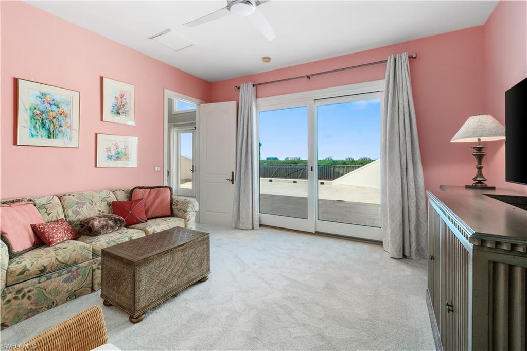 208 Audubon Boulevard Naples, FL 34110 - Photo 35 of 45 a living room with furniture and a large window