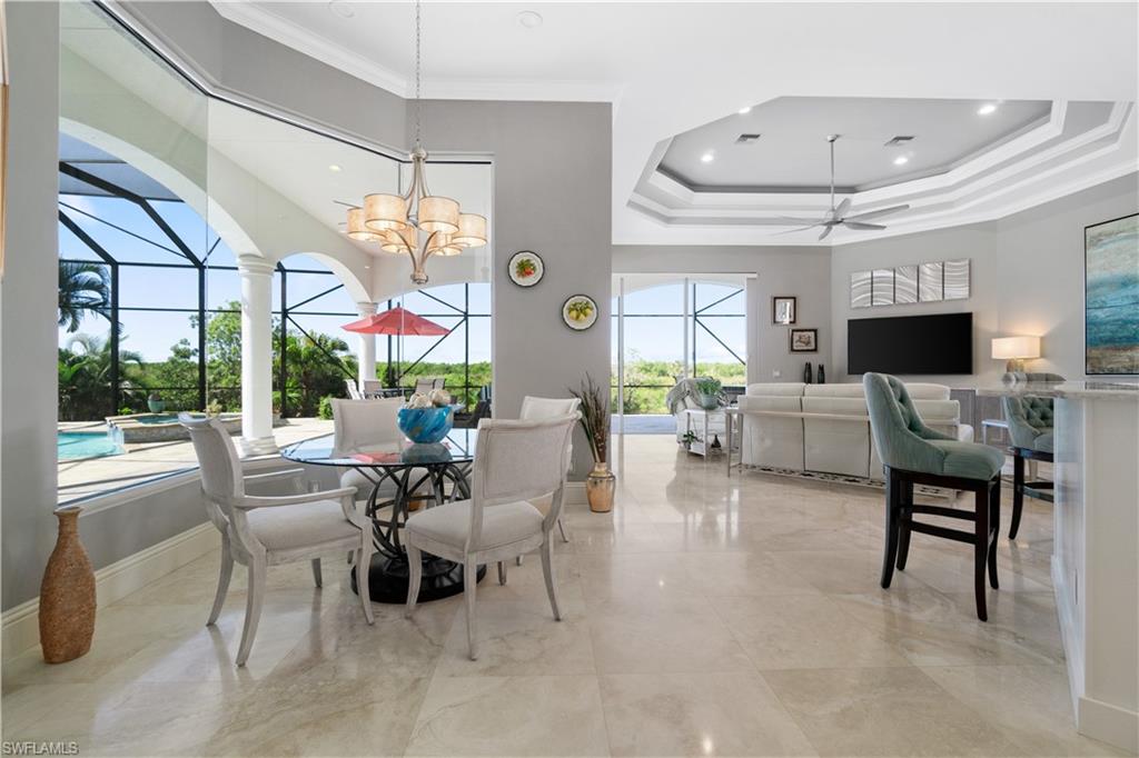 208 Audubon Boulevard Naples, FL 34110 - Photo 4 of 45 a living room with furniture and a large window