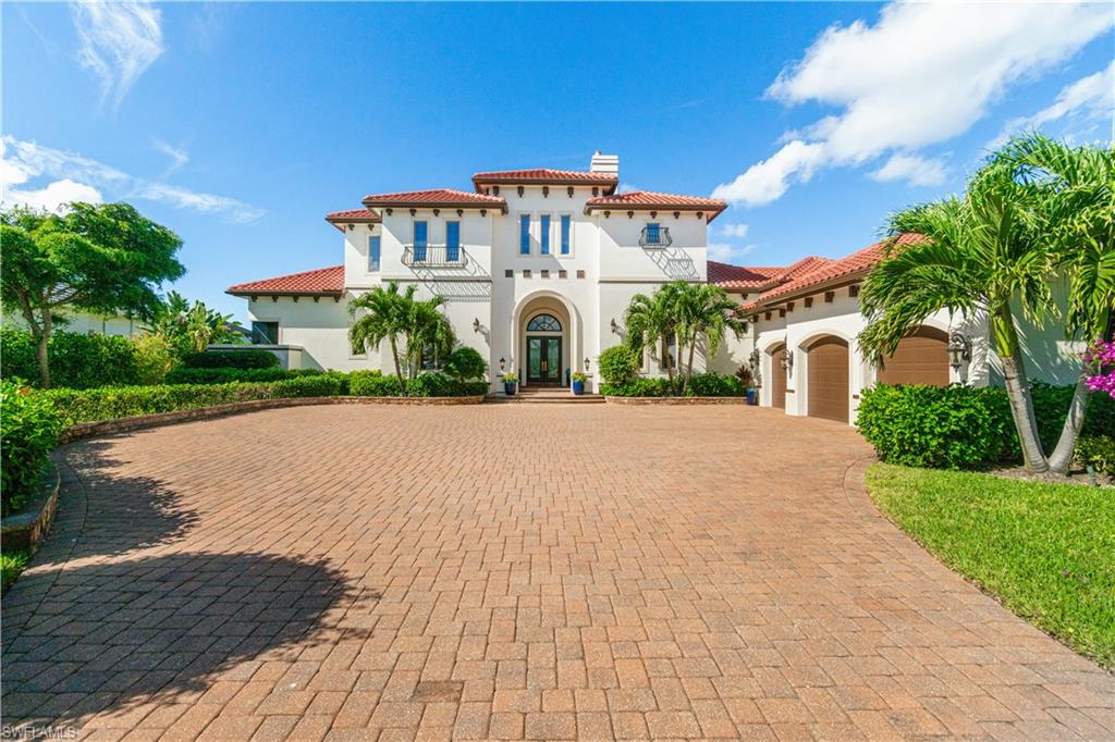 208 Audubon Boulevard Naples, FL 34110 - Photo 45 of 45 a front view of a house with a garden