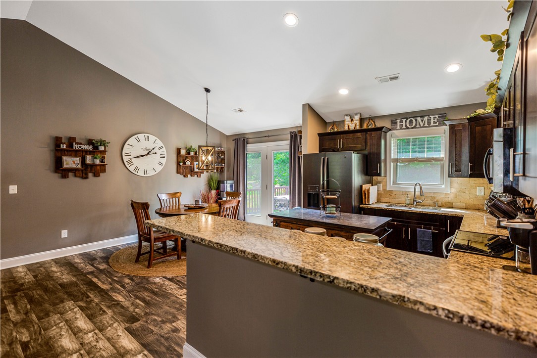 842 Conneross Road Townville, SC 29689 - Photo 11 of 34 An inviting kitchen and dining area feature vaulted ceilings and ample natural light.