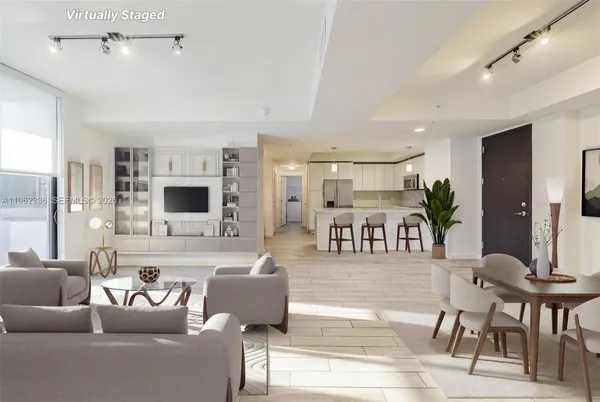 a living room with furniture kitchen view and a flat screen tv