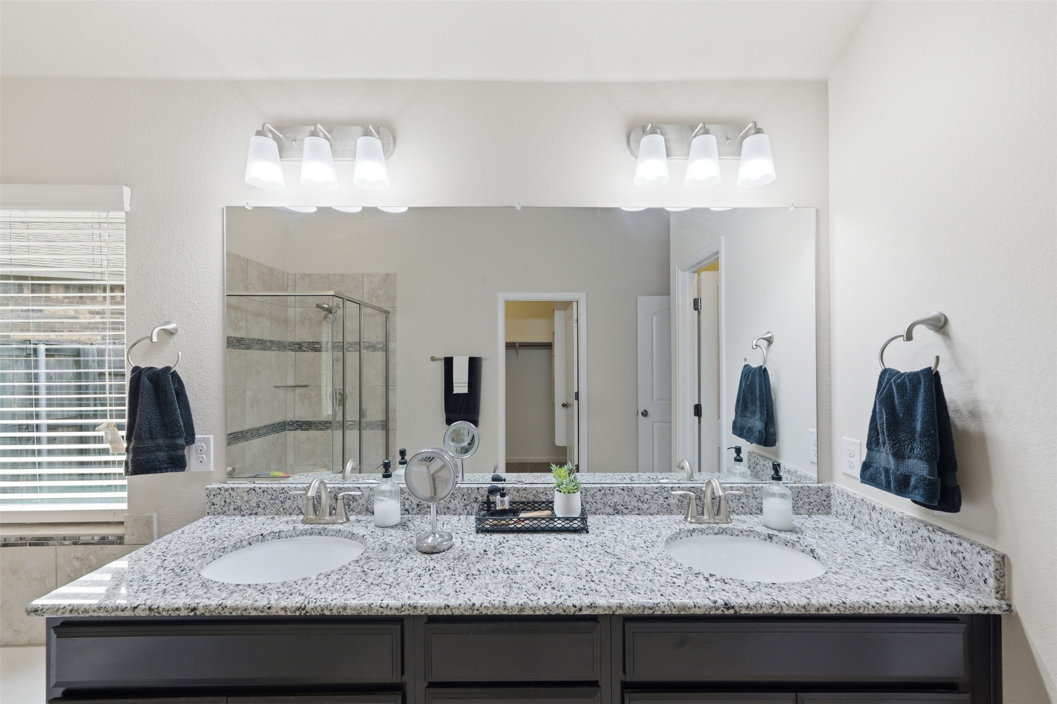 276 Gunnison Way Kyle, TX 78640 - Photo 12 of 28 a bathroom with granite countertop double vanity sinks and a large mirror