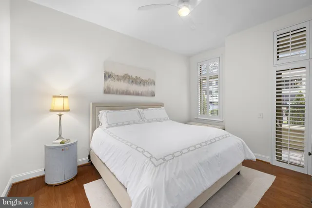 a bedroom with a bed and a night stand