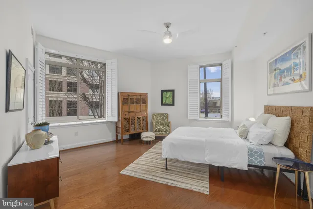 a bedroom with a bed and wooden floor